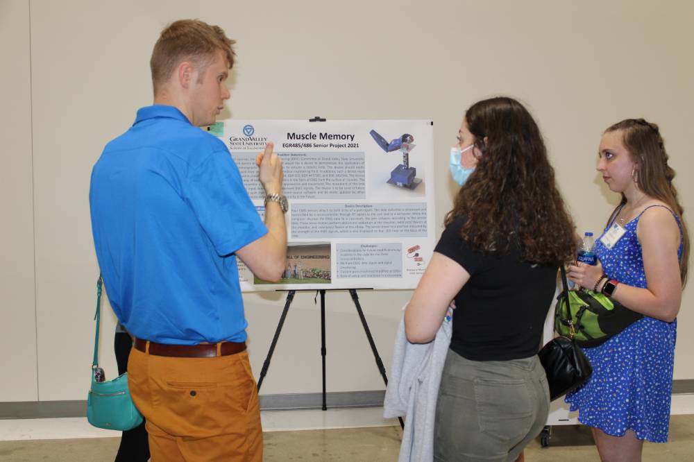A student shares his poster presentation